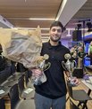 Person in a room, prizes, flowers, smile, 